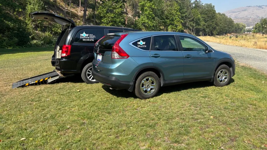 A NOW Shuttle accessible van and SUV parked in the BC Interior countryside