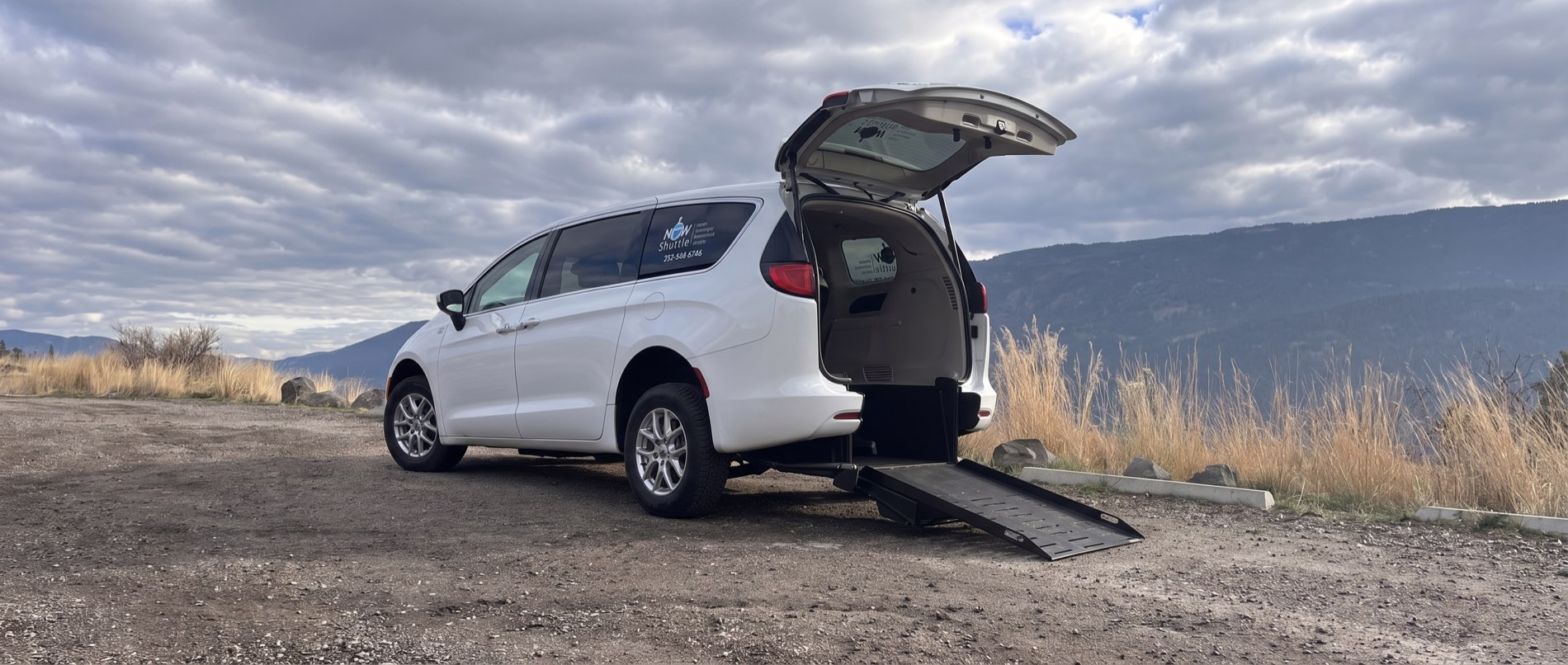 A NOW Shuttle accessible van with its rear-entry ramp deployed in the Okanagan hills